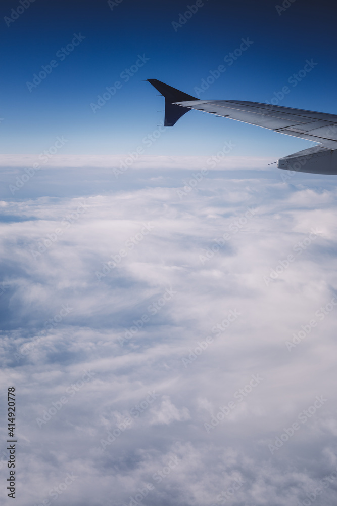 Top view from inside window airplane of blue sky and wing Top view from inside window airplane of blue sky and wing