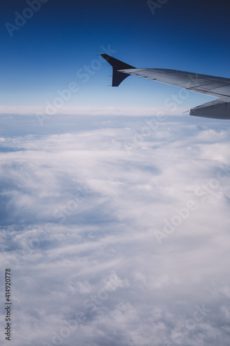 Top view from inside window airplane of blue sky and wing
