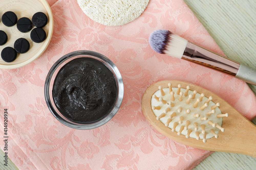 DIY activated charcoal face/hair mask in the small glass bowl, makeup