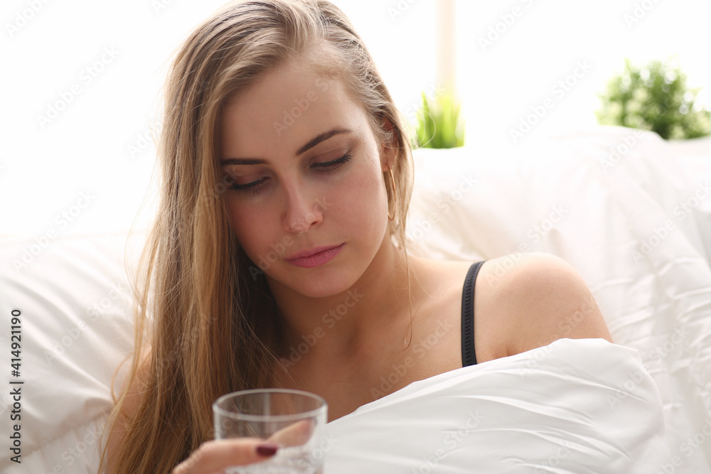 beautiful young blond woman hold glass of water in arm early morning stay in bed beautiful young blond woman hold glass of water in arm early morning stay in bed