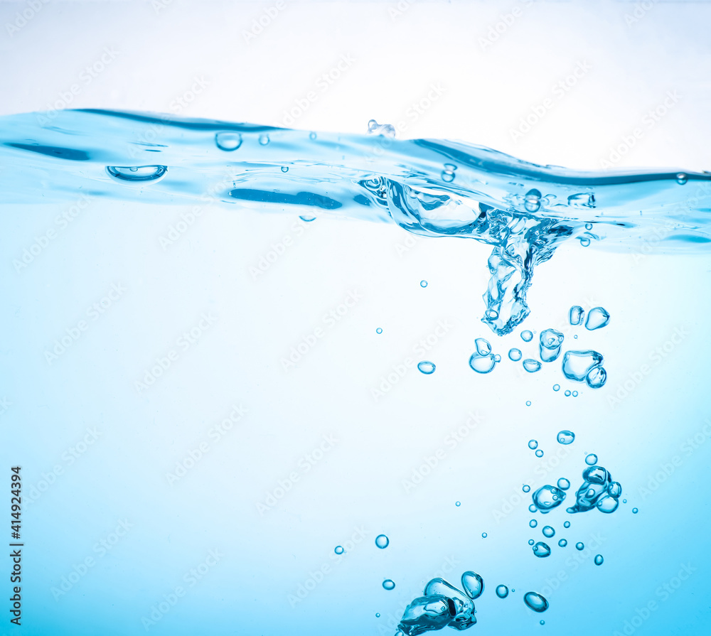 The flow of water creates a splash and the blue waves underwater, and the bubbles naturally flow to the surface. with copy space The flow of water creates a splash and the blue waves underwater, and the bubbles naturally flow to the surface. with copy space