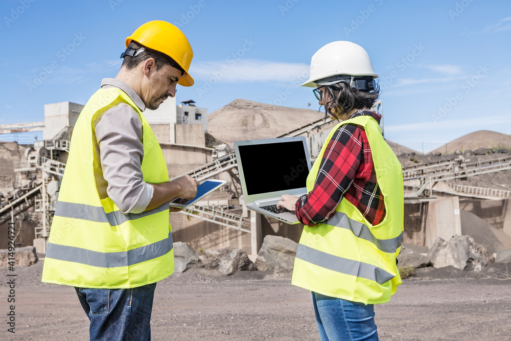 Industrial developers working with gadgets on construction site Industrial developers working with gadgets on construction site