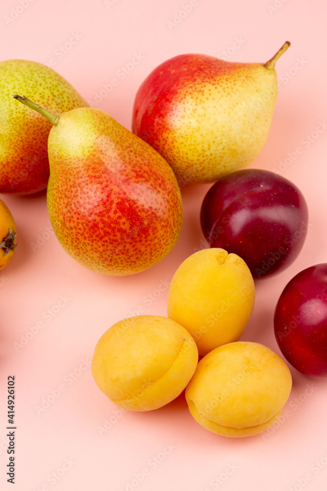 Pears,apricot, cherries on pink background Pears,apricot, cherries on pink background