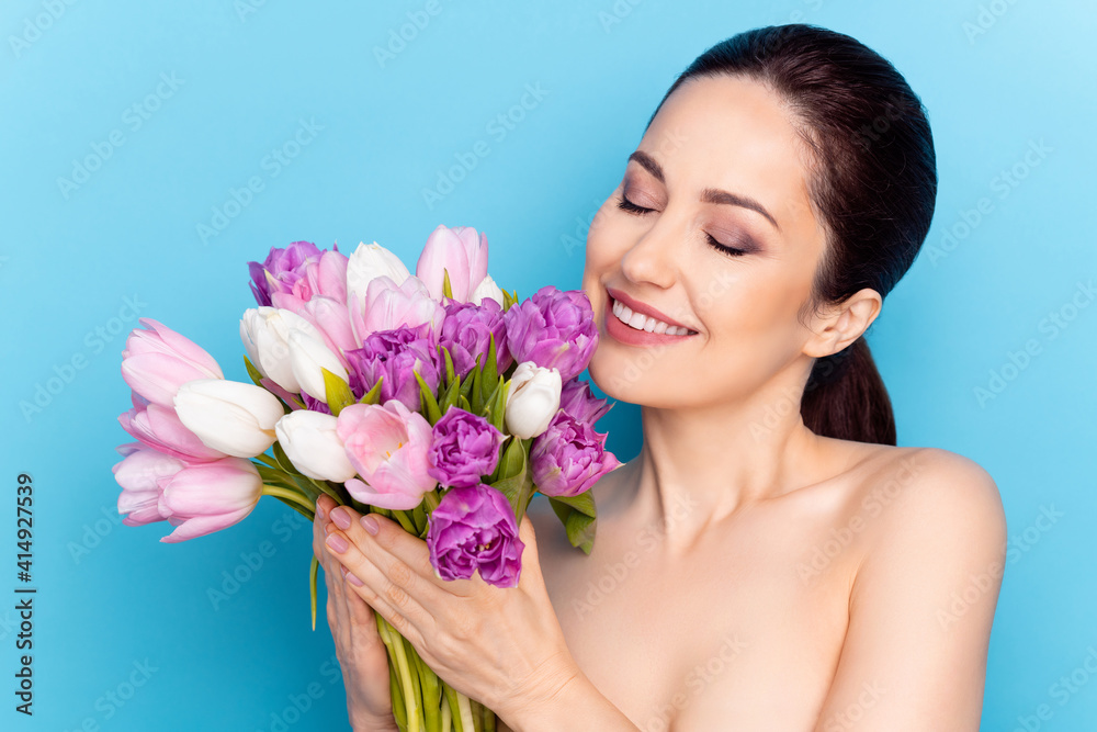 Photo of attractive woman happy smile hold flowers bouquet spring holiday present isolated over blue color background