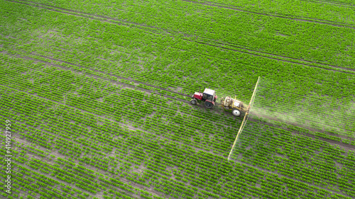 The tractor sprays crops with herbicides  insecticides and pesticides.