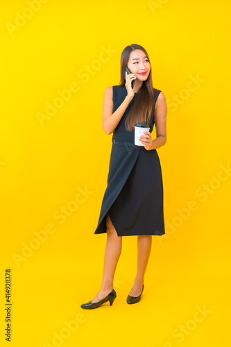 Portrait beautiful young asian business woman with coffee cup and smart mobile phone