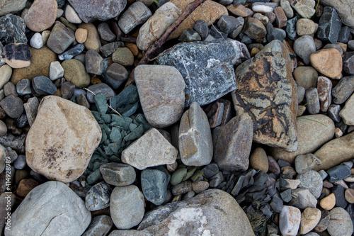 The surface of an old rock with cracks and moss. Old rock texture (wild background)
