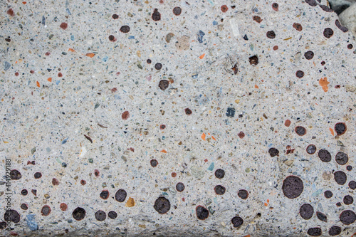 The surface of an old rock with cracks and moss. Old rock texture (wild background)
