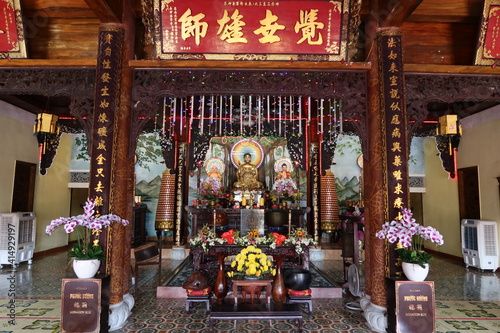 Hoi An, Vietnam, February 18, 2021: Altar with different representations of Buddha in the main hall of the Phap Bao Temple. Hoi An, Vietnam