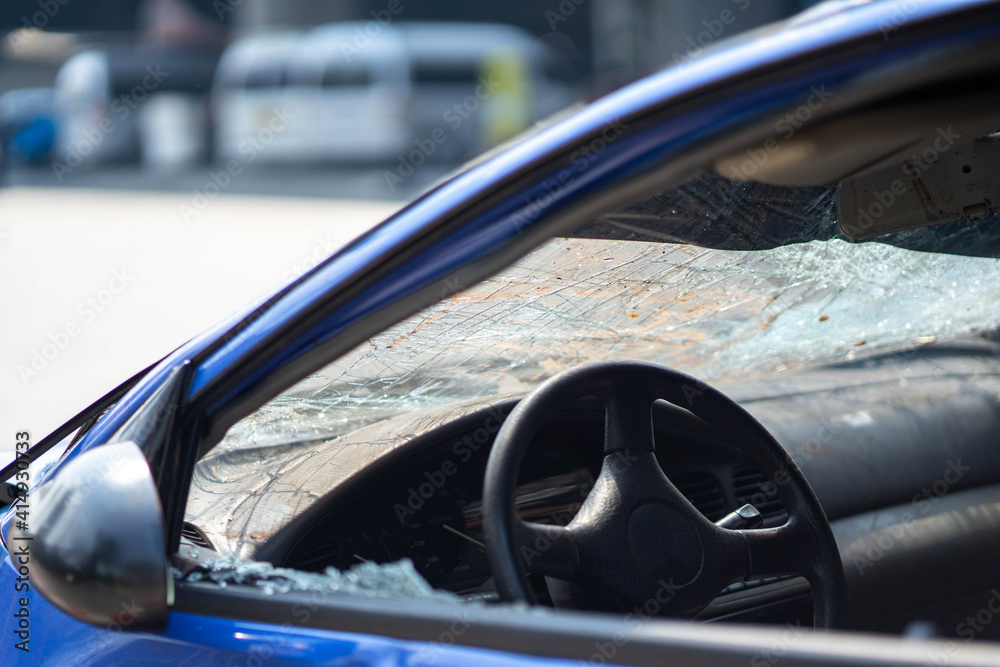 Closeup of car with broken windshield, damaged automobiles.