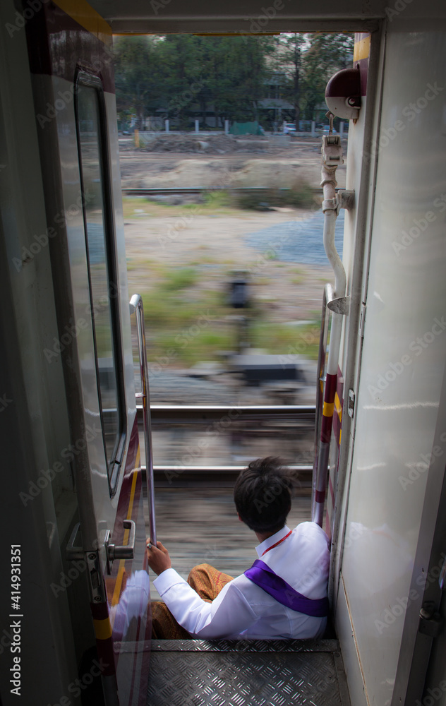 young Thai student on a railroad trip young Thai student on a railroad trip