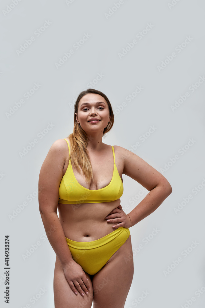 Beautiful curvy young female model wearing yellow underwear