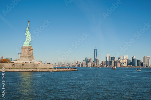 Beautiful sunny views towards the iconic Freedom tower and financial district from Upper Bay Hudson River with Statue of Liberty on the left-hand side, New York City, New York, US