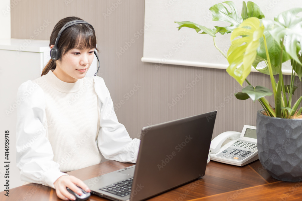 Woman wearing a headset and having a web conference Woman wearing a headset and having a web conference