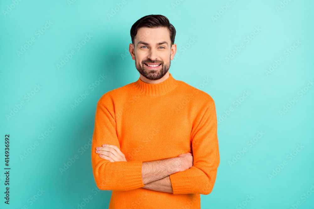 Photo of young cheerful business man happy positive smile confident folded hands isolated over turquoise color background Photo of young cheerful business man happy positive smile confident folded hands isolated over turquoise color background