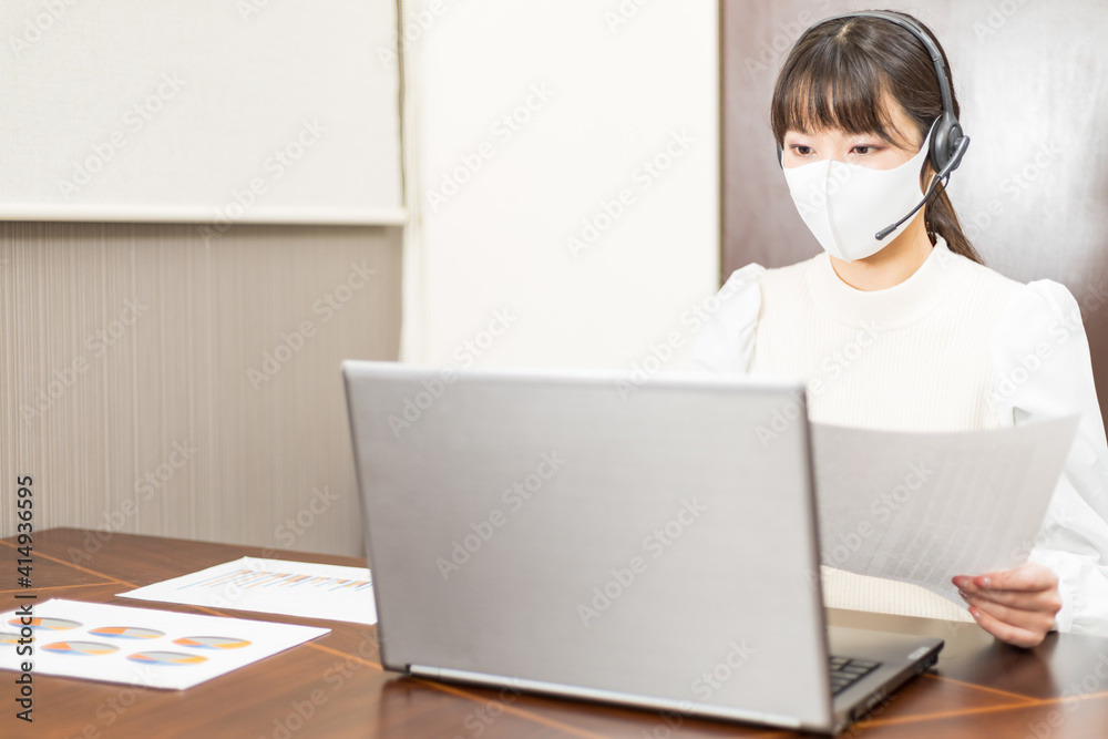 Woman wearing a headset with mask and having a web conference Woman wearing a headset with mask and having a web conference