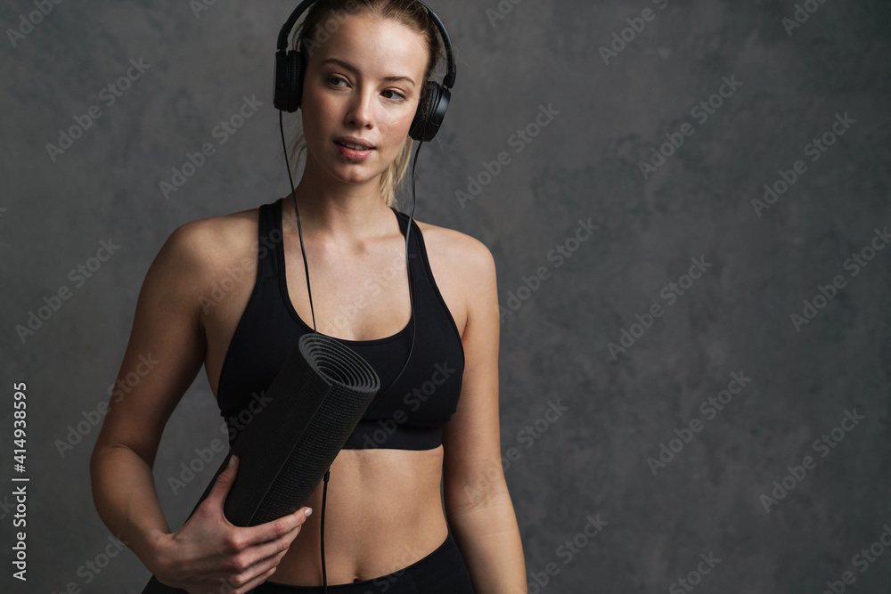 Young athletic woman in wireless headphones Young athletic woman in wireless headphones