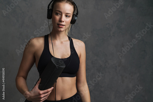Young athletic woman in wireless headphones © Drobot Dean