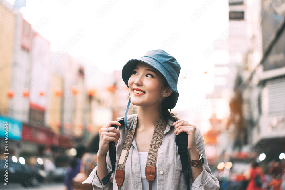 Walking young adult asian woman traveller in city lifestyle at outdoor at chinatown street food market tourism destination.