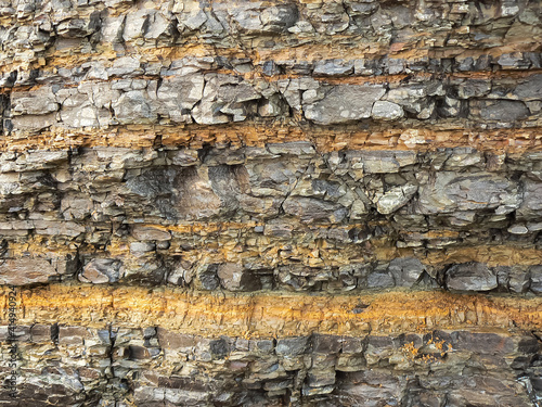 stone background of striped structure with cracks and original texture, rock in Lozhnaya Bay, Shikotan Island, 2020
