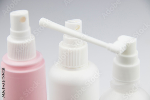cosmetic bottles with a spray bottle on a white background. medicine bottles, disinfection bottles with spray guns © Igorzvencom