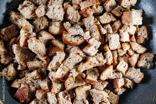 Bread croutons frying in a pan
