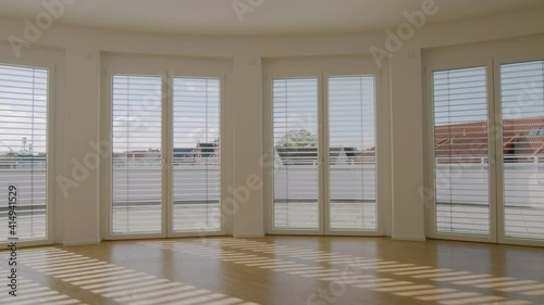 window blinds open and close while panning in an empty apartment