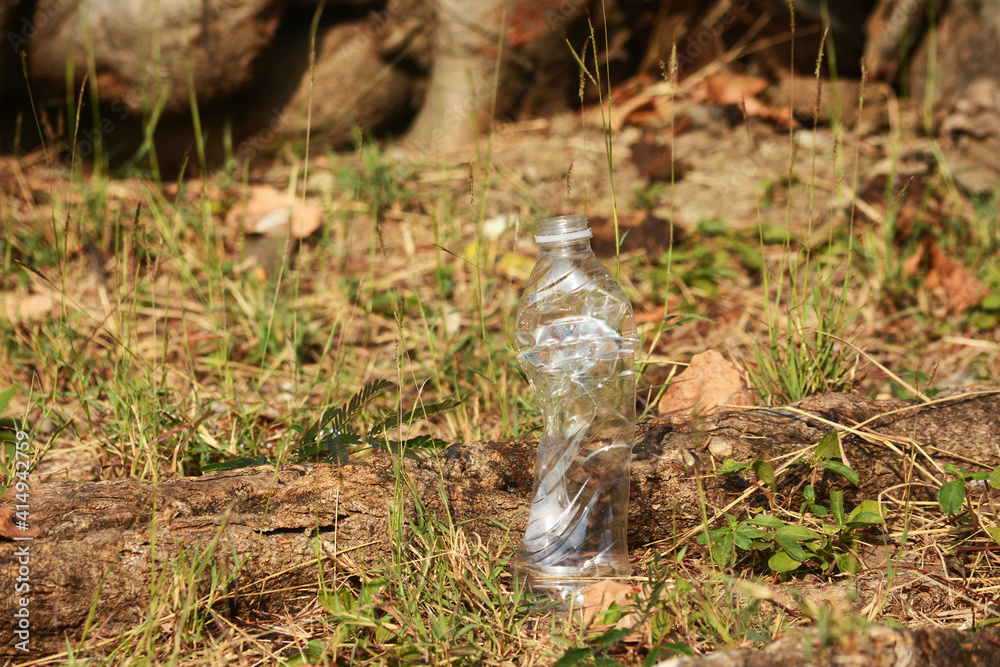 Obraz premium a plastic bottle lies on grass in nature like garbage