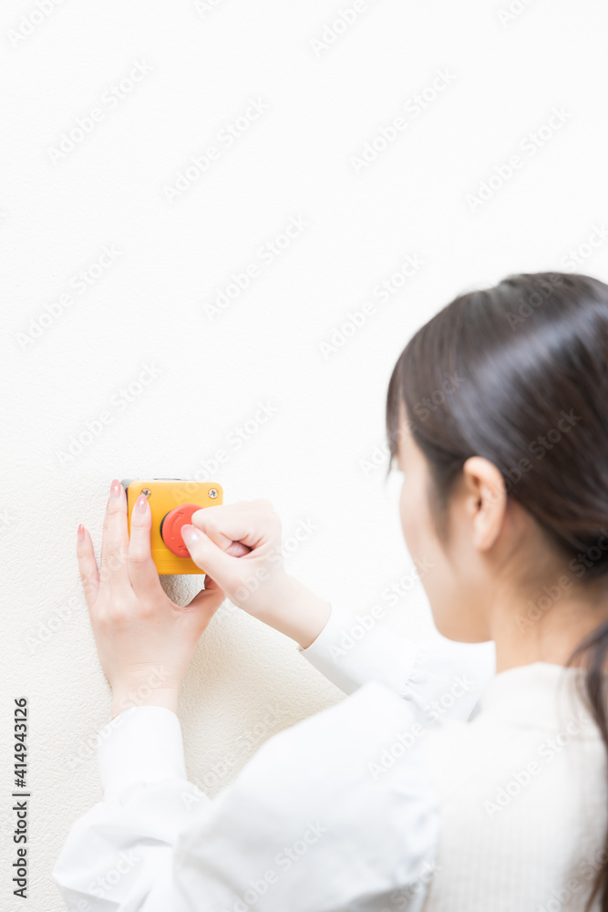 Woman pushing the emergency switch Woman pushing the emergency switch