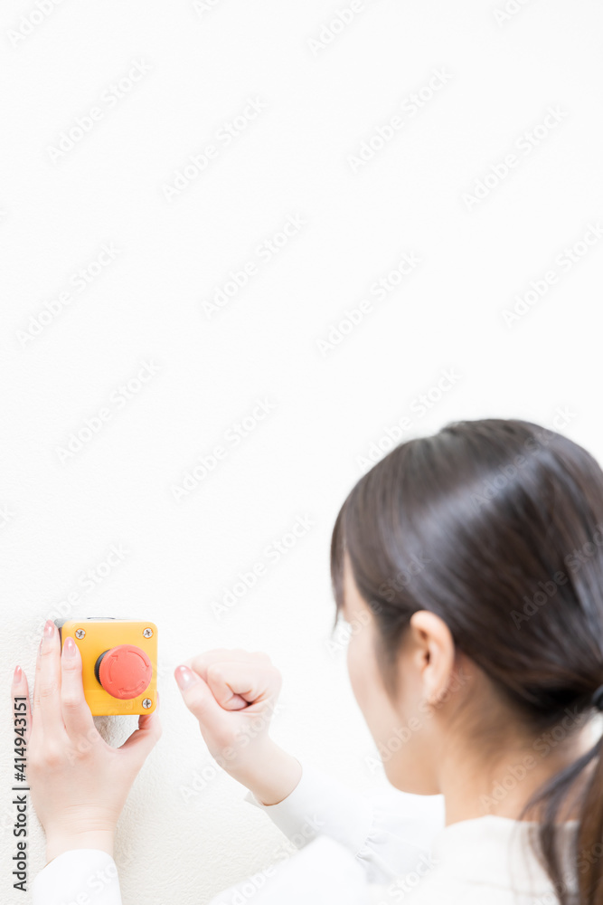 Woman trying to press the emergency switch Woman trying to press the emergency switch
