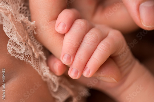 baby s fingers in mom s hand  mohawk newborn
