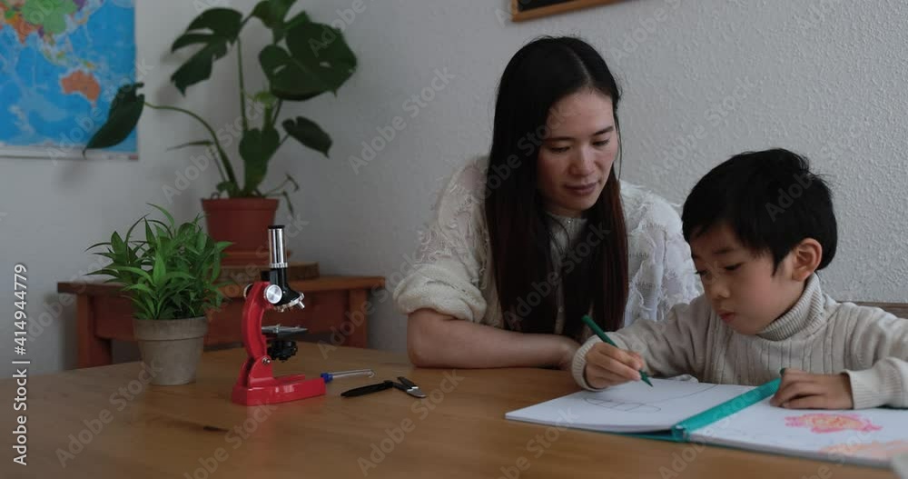Asian mother doing drawing activities with little son at home - Mother and child love Asian mother doing drawing activities with little son at home - Mother and child love