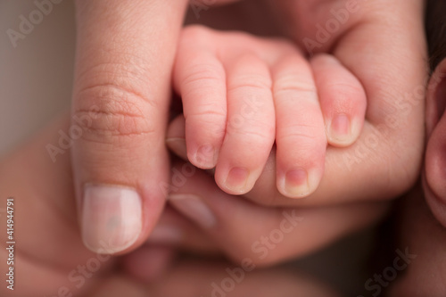 baby's fingers in mom's hand  mohawk newborn