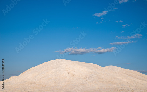 Chalky hill on a background of blue cloudy sky.