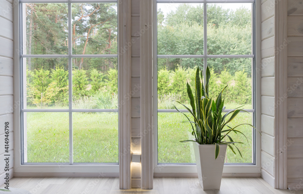 Bright photo studio interior with big window, high ceiling, white wooden floor Bright photo studio interior with big window, high ceiling, white wooden floor
