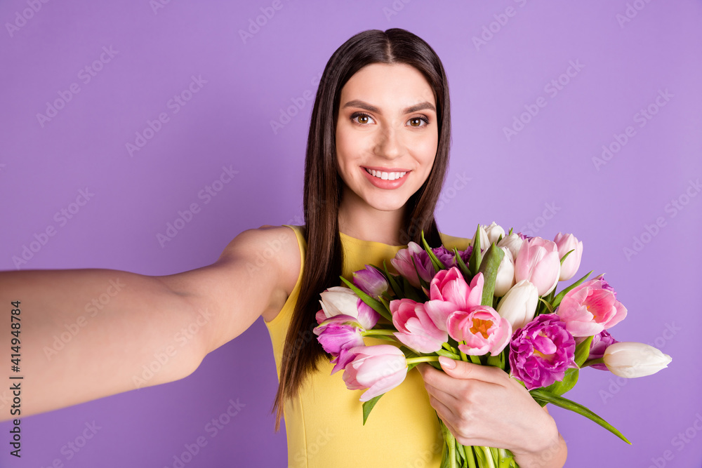 Self-portrait of pretty cheerful girl holding tulips good mood festal occasion isolated over violet purple pastel color background Self-portrait of pretty cheerful girl holding tulips good mood festal occasion isolated over violet purple pastel color background