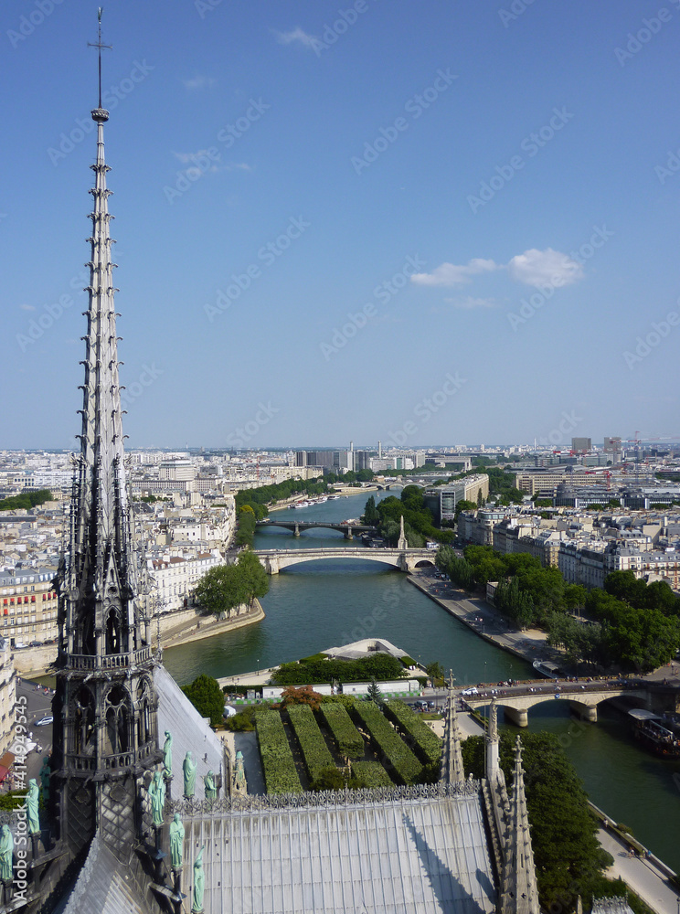 The spire of the Notre-Dame Cathedral in Paris before being destroyed by the 2019 fire gazes imperiously at the River Seine