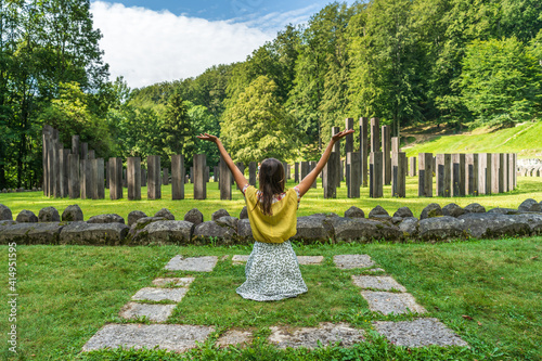 Caucasian girl sitting in front of the sacred zone in Sarmizegetusa Regia fortress, the capital and the most important military, religious and political centre of the Dacians in Romania.  photo