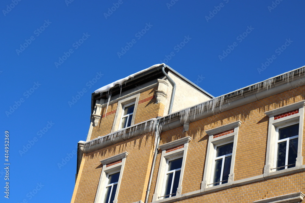 Icicles hanging from top of building