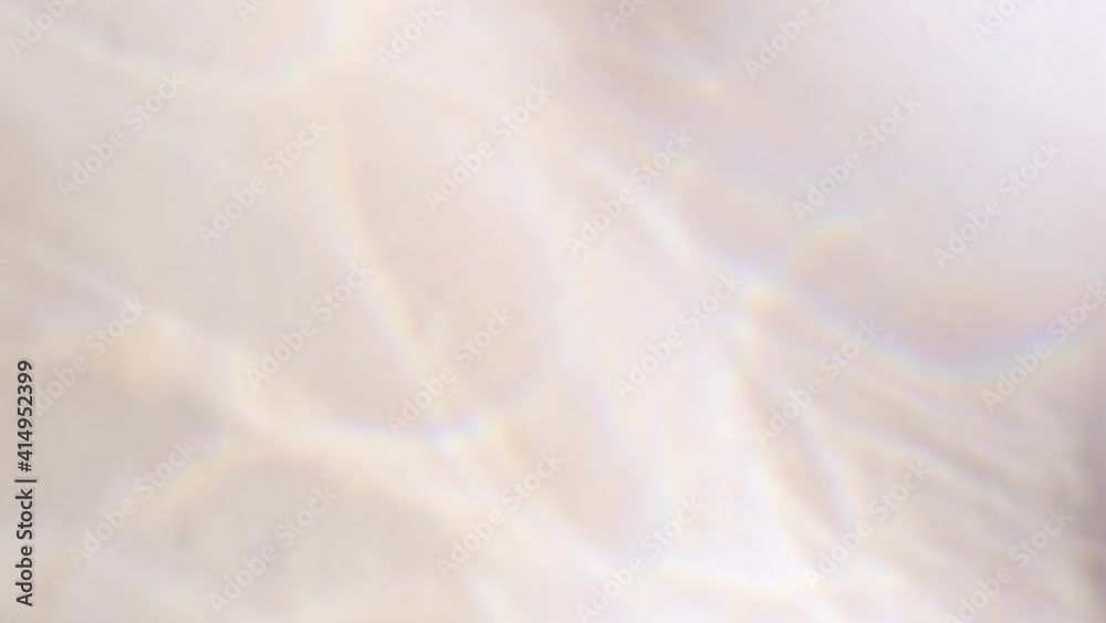 Water rays of light reflections shadow overlay effect through glass on a white background with rainbow reflection. Abstract blurred crystal glasses light. 
