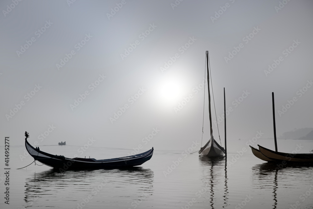 Traditional fisherman wooden boats in the fog