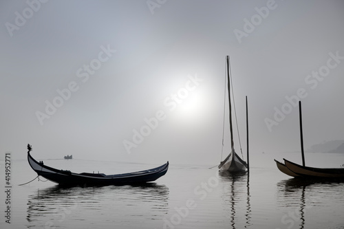 Traditional fisherman wooden boats in the fog © Zacarias da Mata