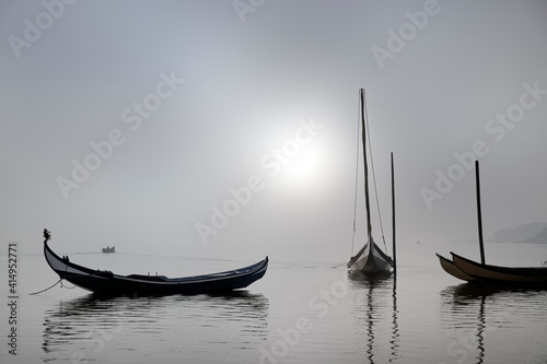 Traditional fisherman wooden boats in the fog