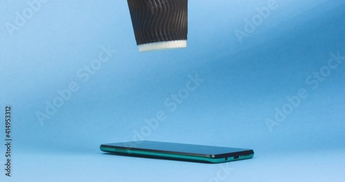 Hand takes out a cup of coffee from smartphone. Coffee Take Away Order Online Delivery concept.