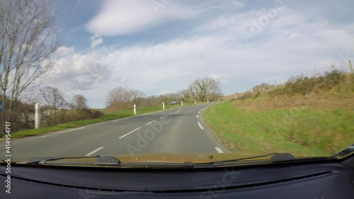 Point of view of car driving on country road in the French Basque Country, camera mounted inside the car on windscreen