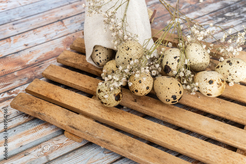 Quail eggs on burlap. Healthy food. Quail eggs lie on a wooden surface, selective focus. Rustic style. Easter concept