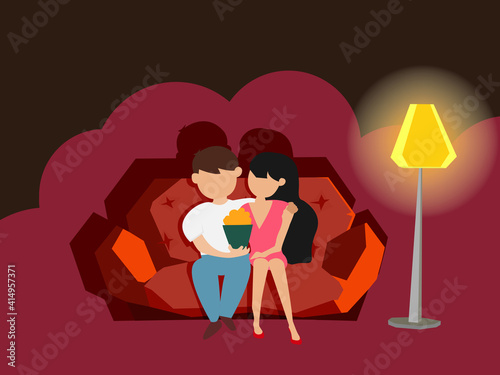 Couple in love siitting on Honeymoon seat in theater