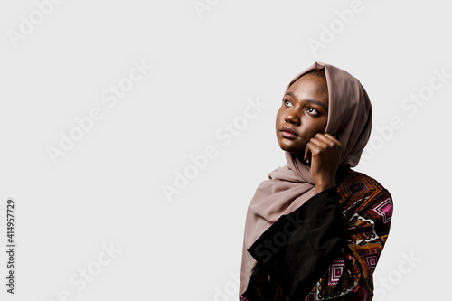 Dreamy black girl weared hijab smile and rejoise on white background. Muslim happy woman posing in studio. Attractive african female. photo