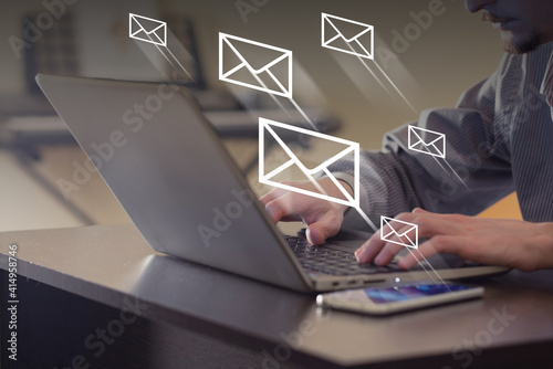 Mail flying away from laptop. Person sending mail in office. Communication, remote working and instant messaging concept