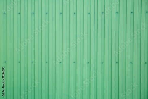 Green-colored metal ribbed surface.